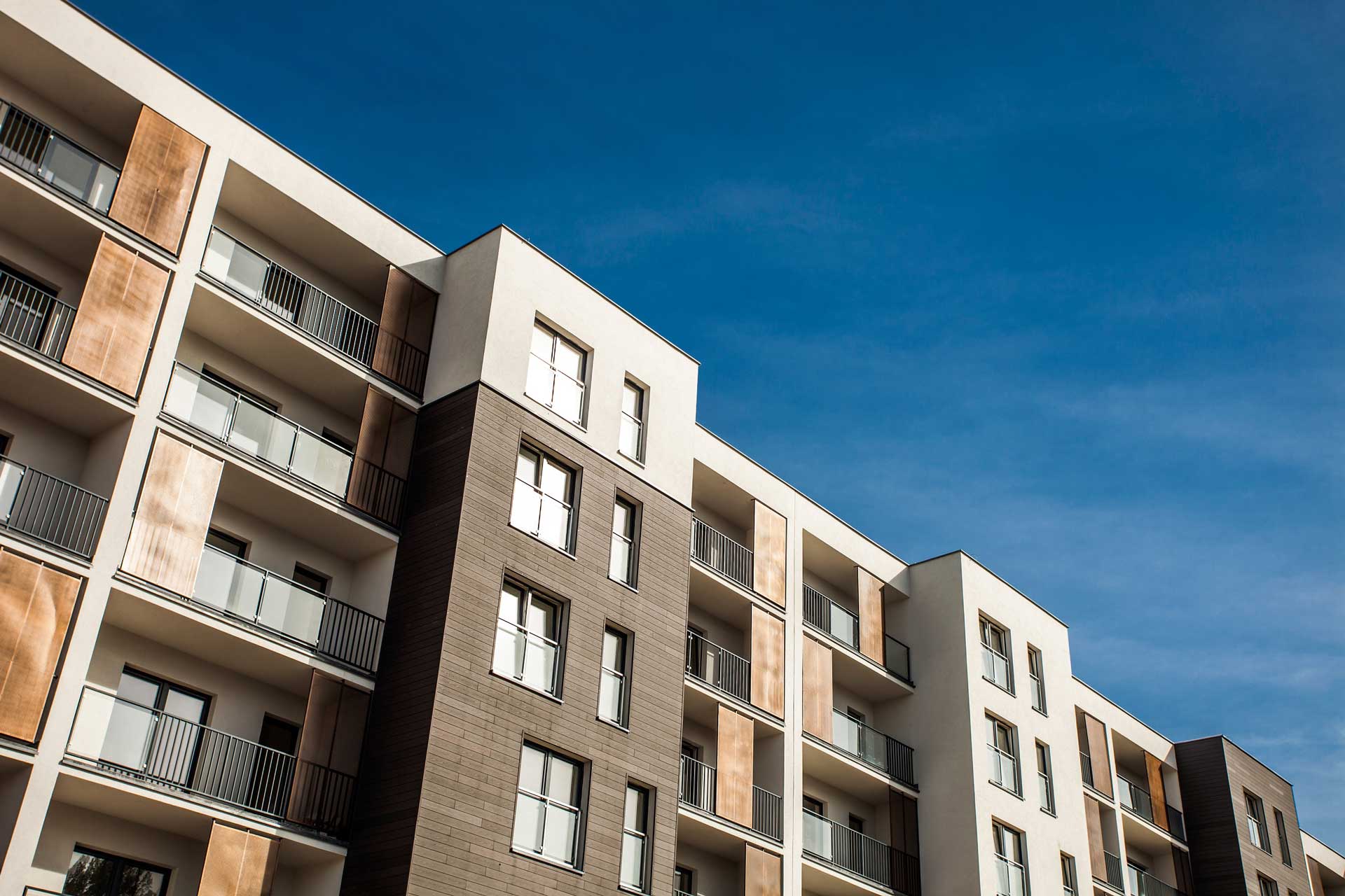 energy efficient aluminium widnows on a flat block with a blue sky